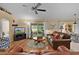 Bright living room features hardwood floors, comfortable seating, and a seamless transition to the dining area at 17355 Se 110Th Ter, Summerfield, FL 34491
