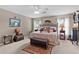 Spacious main bedroom featuring a decorative bed frame, an area rug, and abundant natural light for a relaxing retreat at 17355 Se 110Th Ter, Summerfield, FL 34491