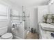 Bright bathroom featuring a glass-enclosed shower, modern vanity, and tasteful décor at 17824 Se 87Th Bourne Ave, The Villages, FL 32162