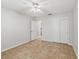 Bedroom featuring tile floor, standard closet, and view into hallway at 17824 Se 87Th Bourne Ave, The Villages, FL 32162