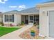 Inviting front entrance with a screened-in porch and neatly landscaped surroundings at 17824 Se 87Th Bourne Ave, The Villages, FL 32162