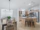 Modern kitchen and dining area with stainless steel appliances and a spacious island with seating at 17824 Se 87Th Bourne Ave, The Villages, FL 32162