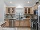 A beautifully appointed kitchen features stainless steel appliances, light wood cabinets, and granite countertops at 17824 Se 87Th Bourne Ave, The Villages, FL 32162