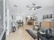 This home features an open living area with dining and kitchen, tile flooring, and a neutral color palette at 17824 Se 87Th Bourne Ave, The Villages, FL 32162