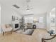 Comfortable living room featuring a fireplace, neutral decor, and a cozy seating area at 17824 Se 87Th Bourne Ave, The Villages, FL 32162