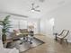 Cozy living room featuring neutral colors, tile flooring, and a ceiling fan at 17824 Se 87Th Bourne Ave, The Villages, FL 32162