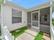 Enclosed patio features concrete pavers and screen enclosure leading to a white picket fence, blending indoor/outdoor living at 17824 Se 87Th Bourne Ave, The Villages, FL 32162