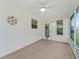Covered patio featuring screened openings, concrete floors, with a ceiling fan and lighting at 17824 Se 87Th Bourne Ave, The Villages, FL 32162
