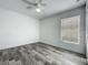 A bedroom with wood-look floors and a window for natural light at 2019 Newtown Rd, Groveland, FL 34736