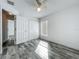 This bedroom has wood look tile floors and a ceiling fan for added comfort at 2019 Newtown Rd, Groveland, FL 34736