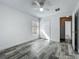Bedroom with wood-look floors, ceiling fan, closet and window at 2019 Newtown Rd, Groveland, FL 34736