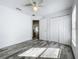 Bedroom with wood look tile flooring, window and closet at 2019 Newtown Rd, Groveland, FL 34736