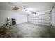 Spacious garage with a translucent door allowing for ample natural light and visibility, enhancing functionality at 2019 Newtown Rd, Groveland, FL 34736
