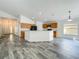 Bright, open kitchen with a center island, wood cabinets, and modern appliances at 2019 Newtown Rd, Groveland, FL 34736
