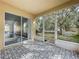 Enclosed patio with decorative tile flooring that flows to the backyard through a screened opening at 2019 Newtown Rd, Groveland, FL 34736
