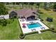Aerial view highlighting the home, pool with spa, fire pit, expansive backyard, and lush surroundings at 23247 Lake Seneca Rd, Eustis, FL 32736