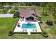 Stunning aerial view of an estate home showcasing a pristine pool, outdoor seating and lush landscaping at 23247 Lake Seneca Rd, Eustis, FL 32736