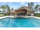Beautiful backyard view of home exterior, pool, patio, and manicured landscaping, perfect for outdoor enjoyment at 23247 Lake Seneca Rd, Eustis, FL 32736