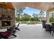 Backyard with a fireplace, pool, seating, and a covered patio, perfect for entertaining at 23247 Lake Seneca Rd, Eustis, FL 32736