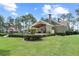 A charming backyard view showcasing the pool, patio, and serene landscaping in a lush, green setting at 23247 Lake Seneca Rd, Eustis, FL 32736