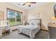 Cozy bedroom with a large window offering natural light and views of the outdoor scenery at 23247 Lake Seneca Rd, Eustis, FL 32736