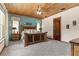 Spacious bedroom featuring a unique wooden bed frame, an area rug, and a light blue accent wall at 23247 Lake Seneca Rd, Eustis, FL 32736