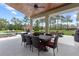 The covered patio features ample space for dining and lounging, overlooking a beautiful lawn and pool area at 23247 Lake Seneca Rd, Eustis, FL 32736
