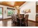 Dining room boasts large windows, a rustic chandelier, and ample seating for a large gathering at 23247 Lake Seneca Rd, Eustis, FL 32736
