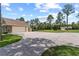 Spacious drive featuring a detached garage, additional building, and expansive lawn at 23247 Lake Seneca Rd, Eustis, FL 32736
