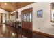 Foyer featuring a stained concrete floor, half wall wet bar, and a front door with glass panes at 23247 Lake Seneca Rd, Eustis, FL 32736