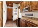 Hallway with custom wooden cabinets with counter space and stainless steel appliances at 23247 Lake Seneca Rd, Eustis, FL 32736
