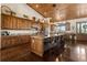 Spacious kitchen with custom wood cabinetry, a large island with bar seating, and stainless steel appliances at 23247 Lake Seneca Rd, Eustis, FL 32736