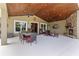 Outdoor patio with a stone fireplace, dining table, and comfortable seating area, perfect for entertaining at 23247 Lake Seneca Rd, Eustis, FL 32736