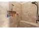 Detailed view of the tiled walk-in shower with a built-in bench and niche for toiletries at 23247 Lake Seneca Rd, Eustis, FL 32736