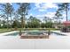 Beautiful swimming pool and jacuzzi area with lounge chairs, set against a lush green landscape at 23247 Lake Seneca Rd, Eustis, FL 32736