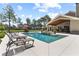 A spacious pool area, featuring lounge chairs and a hot tub, creating a relaxing outdoor retreat at 23247 Lake Seneca Rd, Eustis, FL 32736