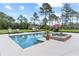 Inviting swimming pool with attached spa, complemented by outdoor seating and meticulously maintained landscaping at 23247 Lake Seneca Rd, Eustis, FL 32736