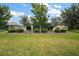 Well-maintained backyard with lush green lawn and meticulous landscaping at 2400 Pawtucket Pass, Mount Dora, FL 32757