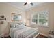 Cozy bedroom with plantation shutters, ceiling fan, and comfortable queen sized bed at 2400 Pawtucket Pass, Mount Dora, FL 32757