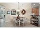 Cozy dining area with a stylish light fixture, adjacent to an open-concept kitchen at 2400 Pawtucket Pass, Mount Dora, FL 32757