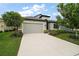 Charming single-story home with a well-manicured lawn and attached two-car garage at 2400 Pawtucket Pass, Mount Dora, FL 32757