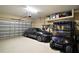 Spacious three car garage featuring epoxy flooring and ample storage solutions at 2400 Pawtucket Pass, Mount Dora, FL 32757