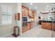 Modern kitchen with stainless oven and light wood cabinetry open to other living spaces at 2400 Pawtucket Pass, Mount Dora, FL 32757