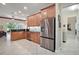 The kitchen features stainless steel appliances, tiled floors, and light wood cabinetry at 2400 Pawtucket Pass, Mount Dora, FL 32757