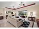 Bright living room with tile floors, ceiling fans, and access to an outdoor patio at 2400 Pawtucket Pass, Mount Dora, FL 32757