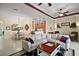Open-concept living room with tile flooring and a view into the kitchen and dining areas at 2400 Pawtucket Pass, Mount Dora, FL 32757