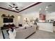 Open-concept living room with modern ceiling fan, decor, and tile flooring provides a welcoming atmosphere at 2400 Pawtucket Pass, Mount Dora, FL 32757