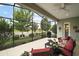 Inviting screened patio with lake view, complete with comfortable seating and barbecue grill at 2400 Pawtucket Pass, Mount Dora, FL 32757