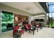 Relaxing screened patio with comfortable seating, ceiling fan, and view into the home at 2400 Pawtucket Pass, Mount Dora, FL 32757