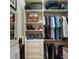 Organized walk-in closet with shelving, drawers, and hanging rods for ample storage at 2400 Pawtucket Pass, Mount Dora, FL 32757